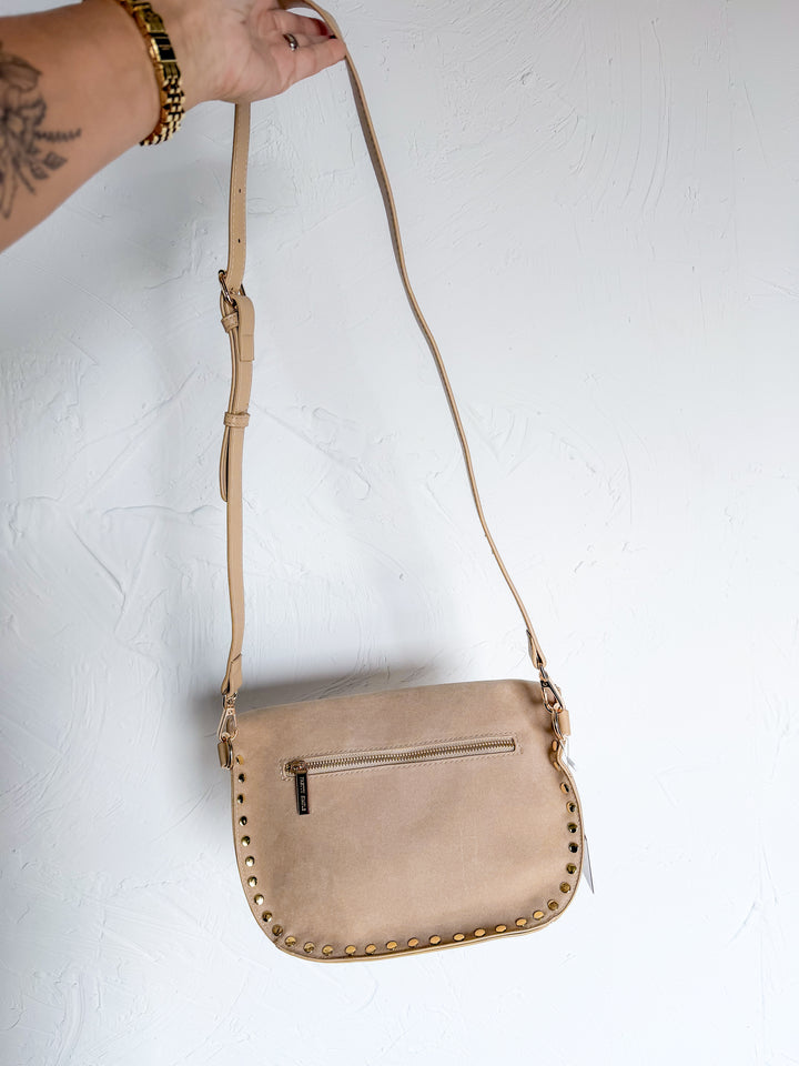 Taupe studded crossbody bag with adjustable strap and front zip pocket