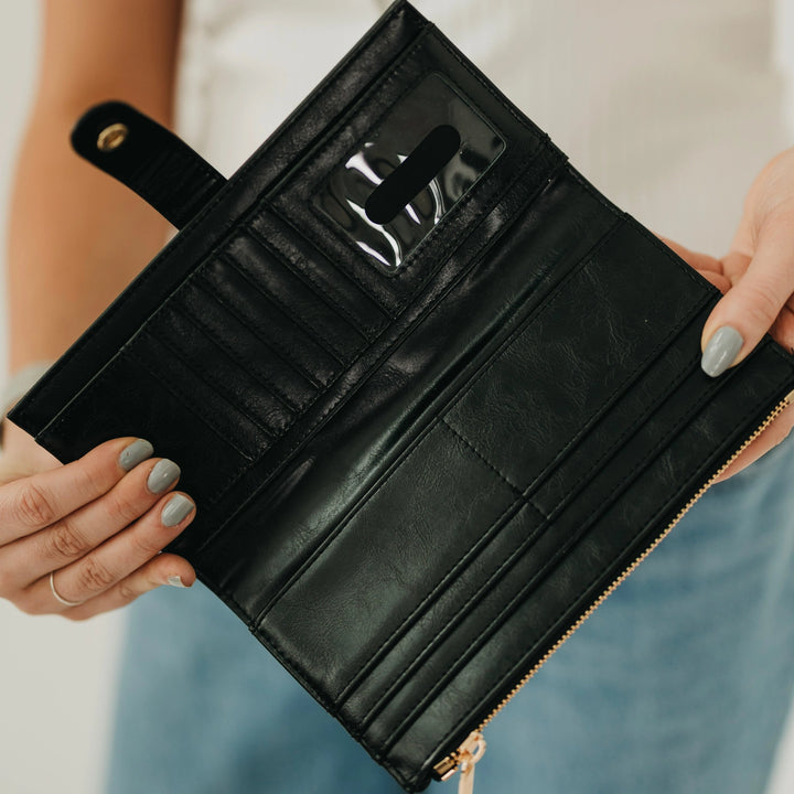 Interior of black wallet showing card slots, clear ID window, and zippered coin pocket
