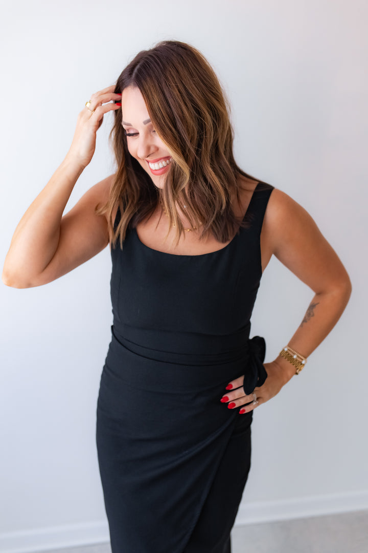Chic black midi dress styled for work or special occasion outfit
