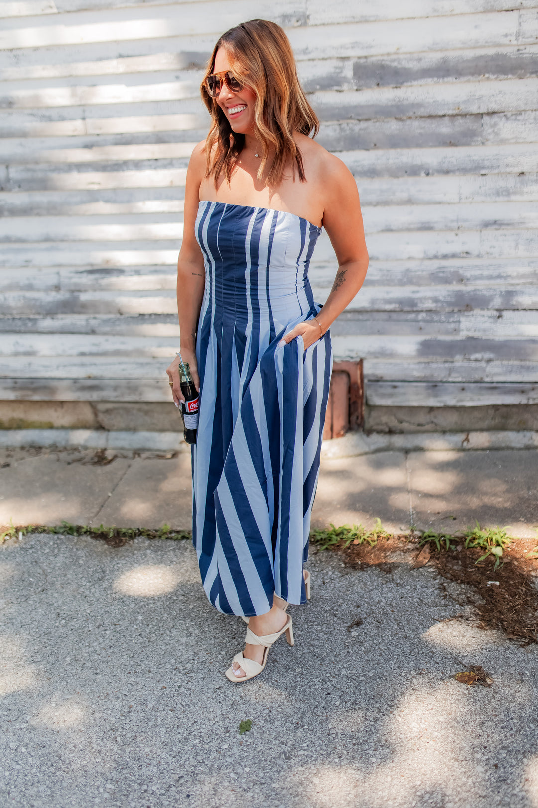 Blue striped strapless midi dress with flowy skirt styled for summer outfit