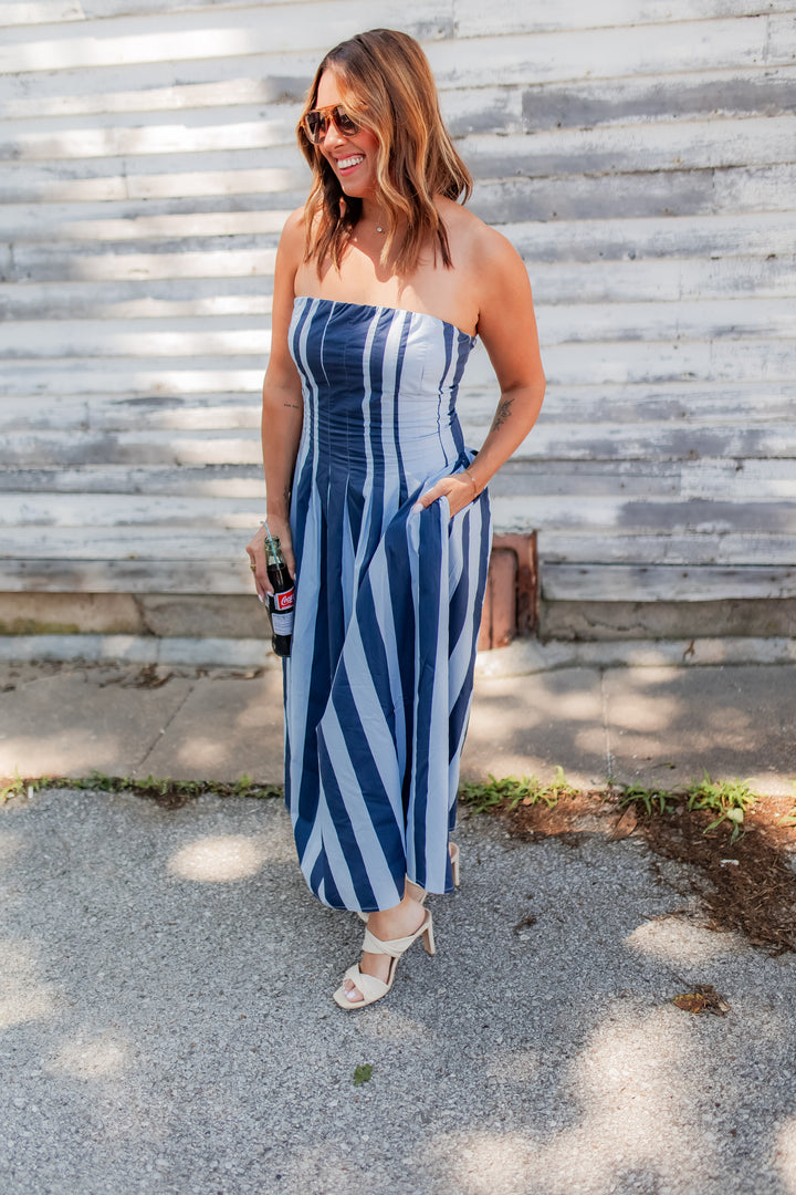 Blue striped strapless midi dress with flowy skirt styled for summer outfit