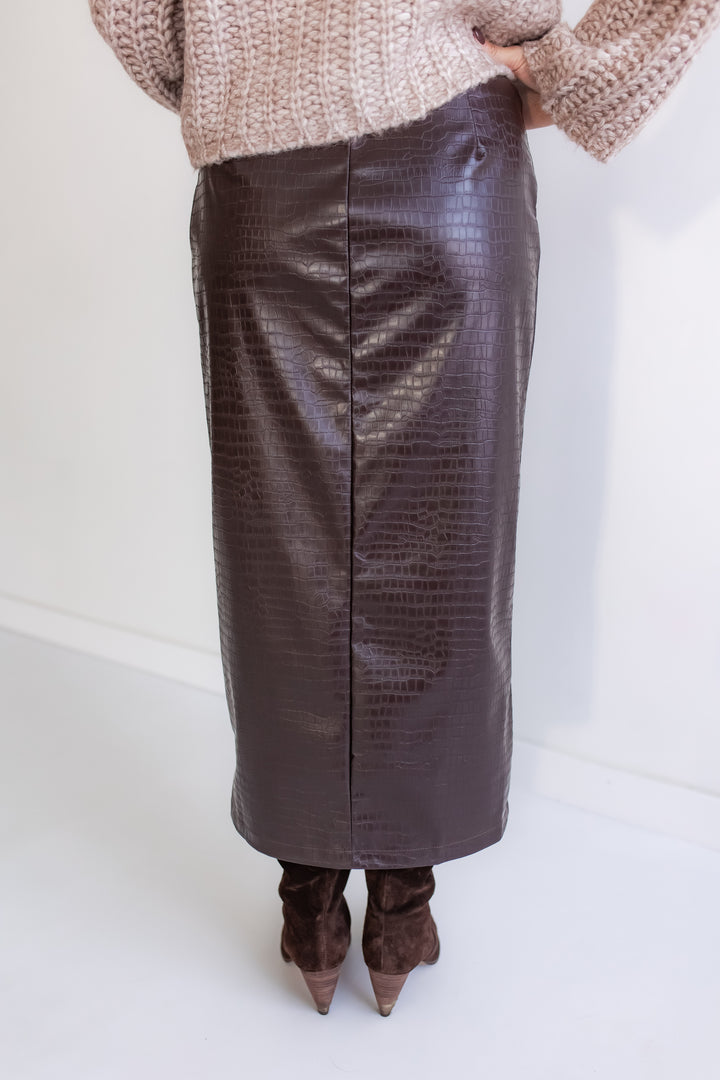 Woman wearing a croc leather midi skirt 