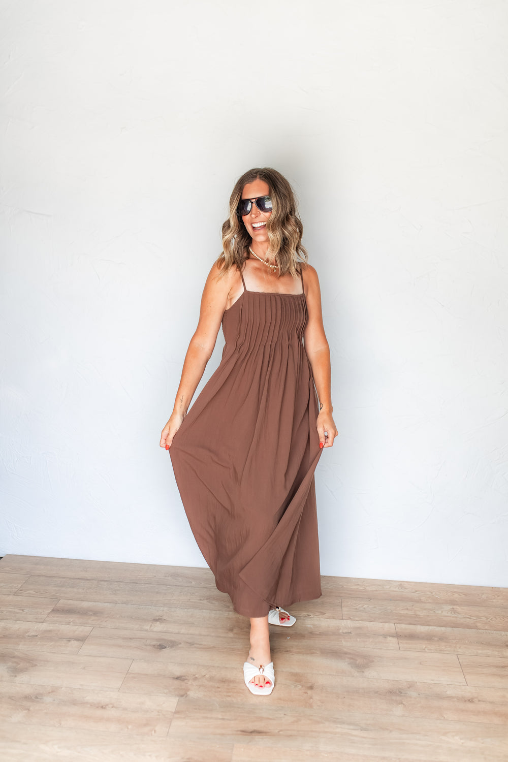 Full length view of brown pintuck pleated bodice maxi dress