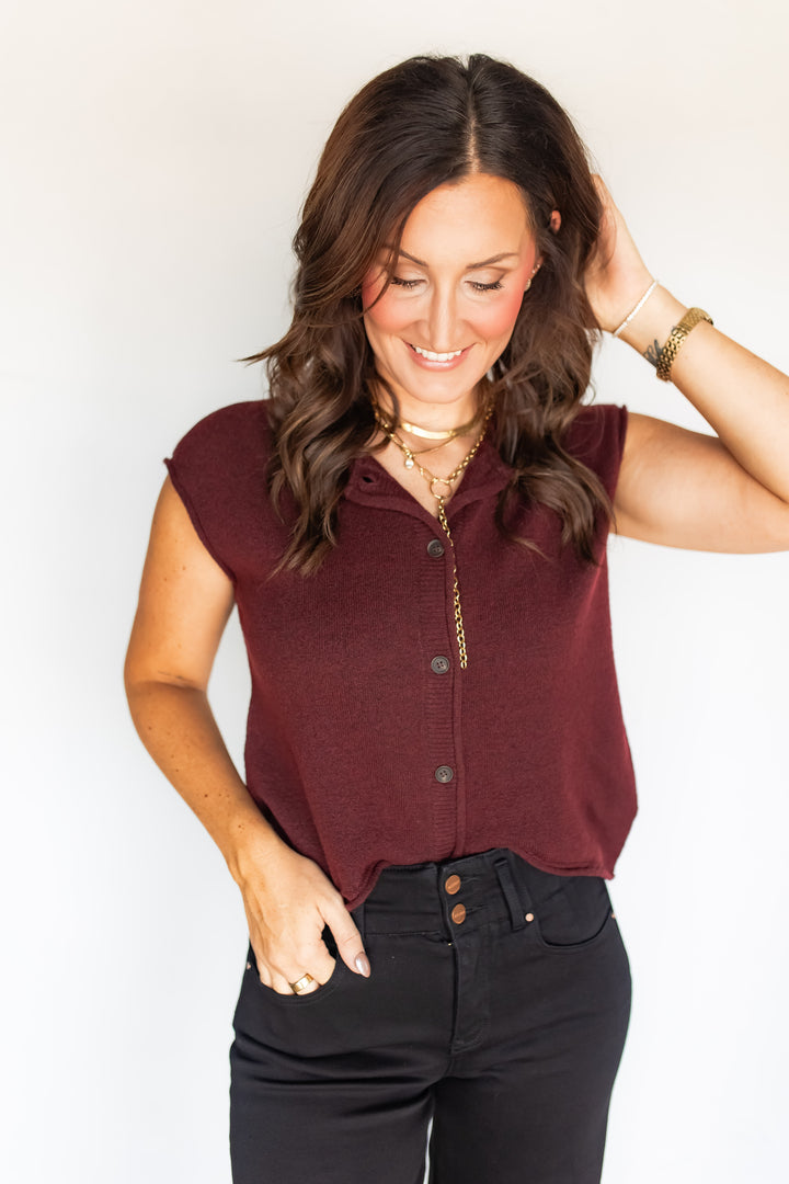 Close-up of burgundy sweater knit top button-front detail