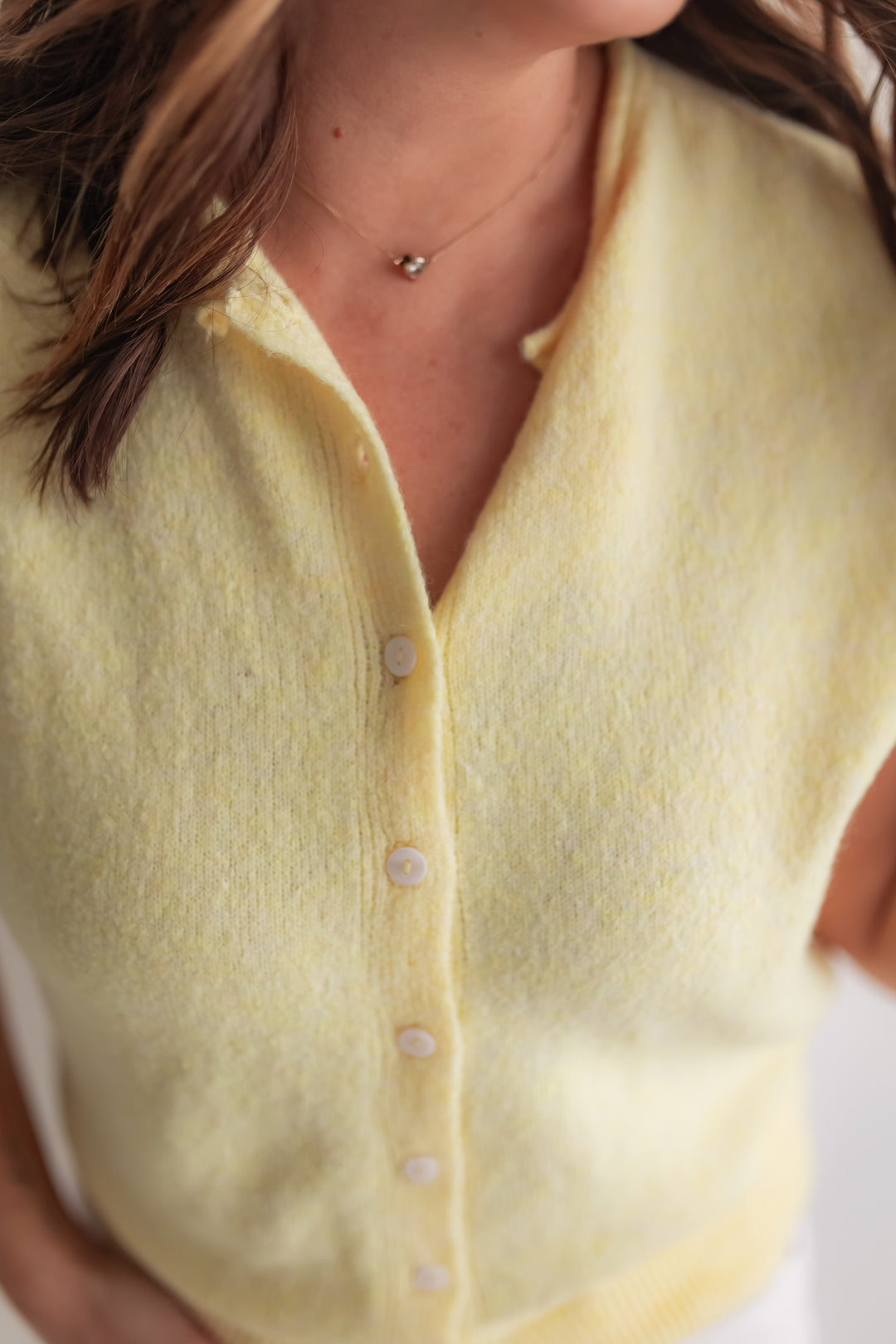 Close up of soft lightweight butter yellow cardigan knit detail
