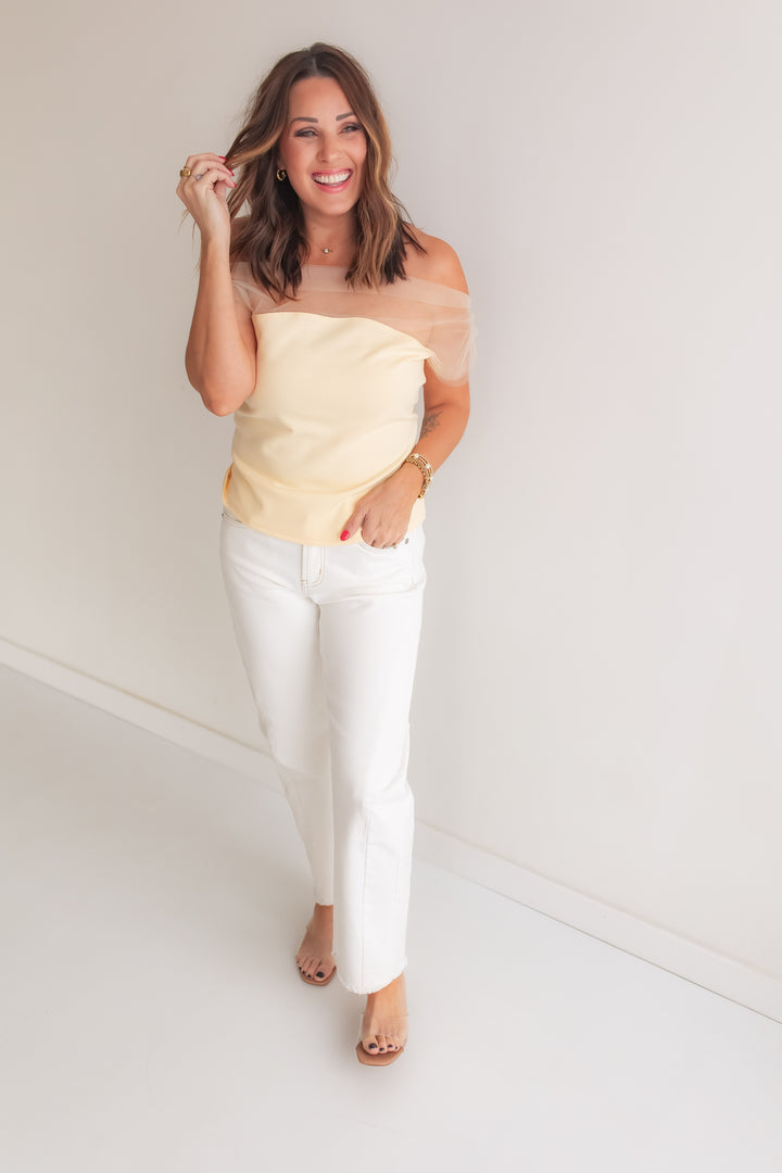 Butter yellow fitted mesh top styled with white pants for a casual spring outfit