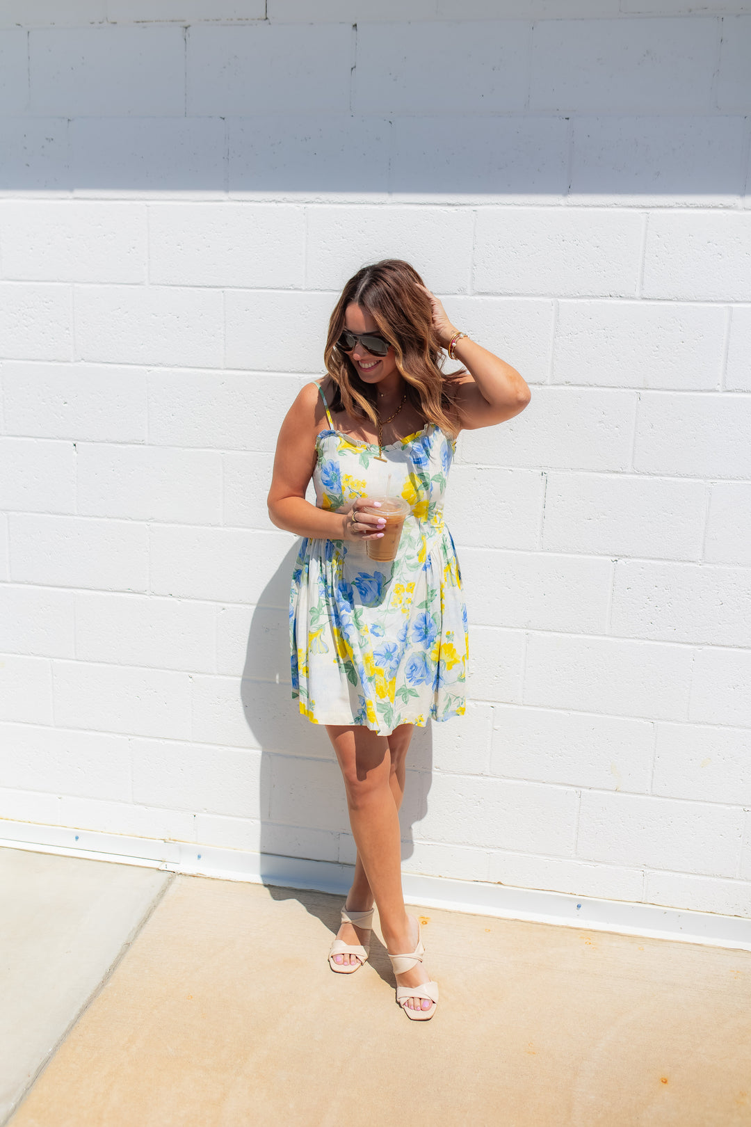 Blue and yellow floral mini dress with a flattering bodice and flowy skirt styled for a summer outfit