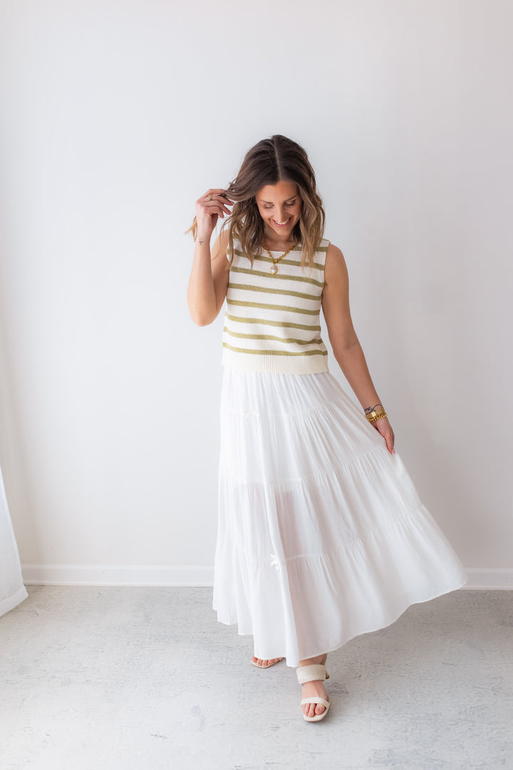 Flowy white maxi skirt paired with knit top for vacation outfit