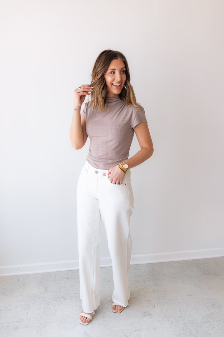 mockneck taupe fitted short sleeve knit top styled with white denim for an everyday neutral outfit