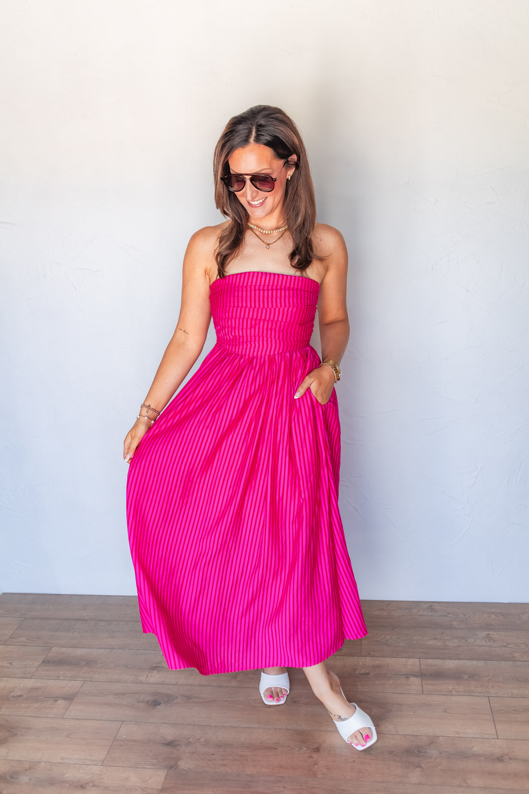 bright pink stripe summer midi dress styled with white sandals. 
