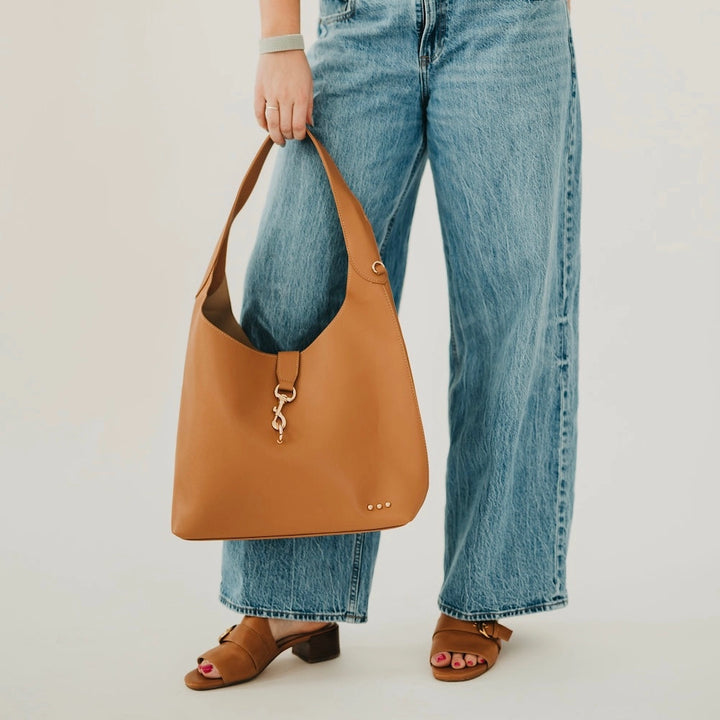 Leather hobo shoulder bag with gold clasp hook detail and wide shoulder strap