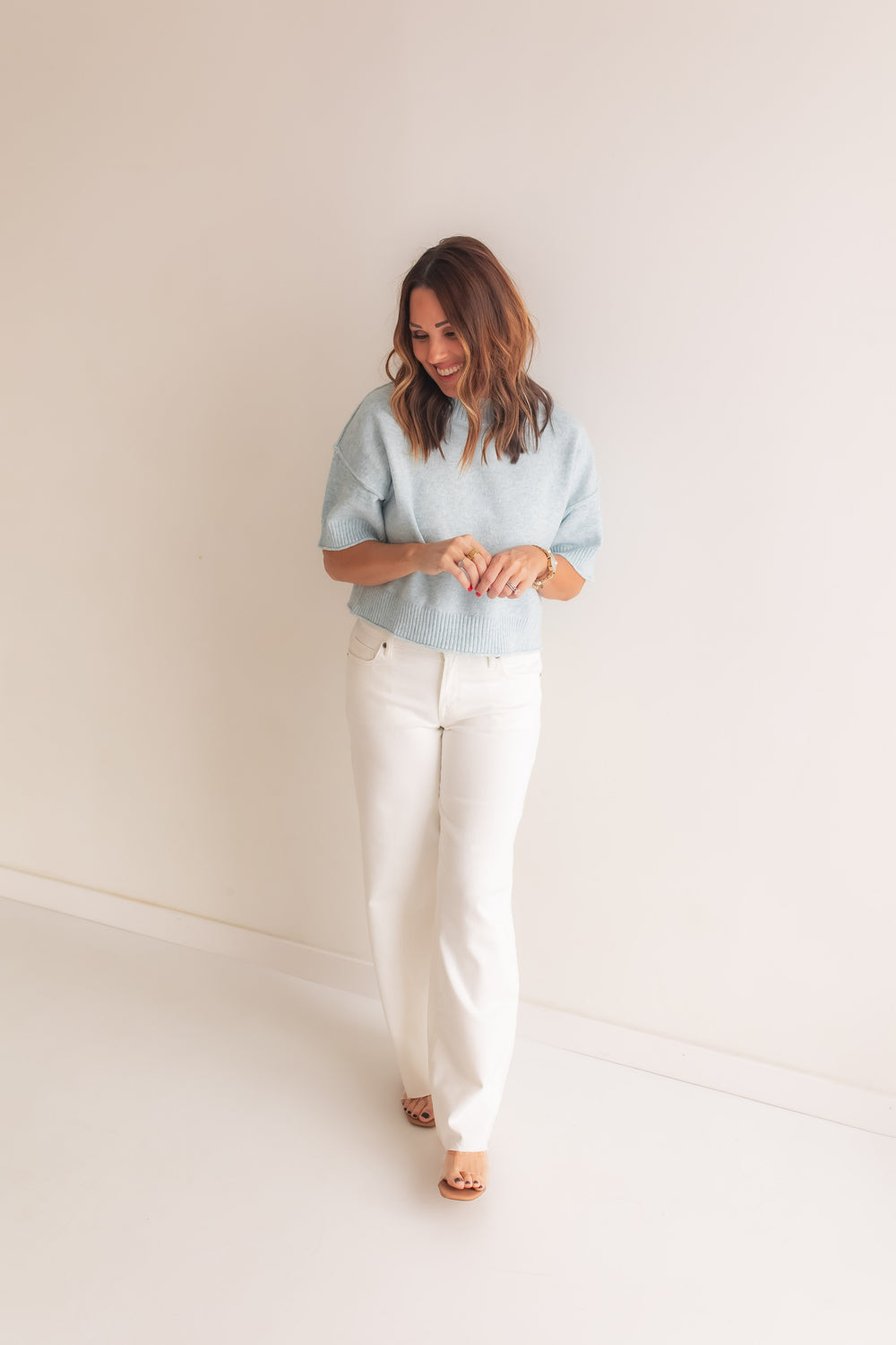 soft light blue sweater top paired with white denim