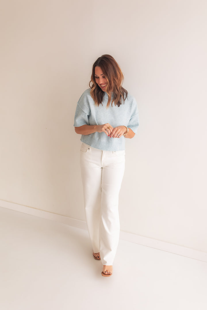 soft light blue sweater top paired with white denim