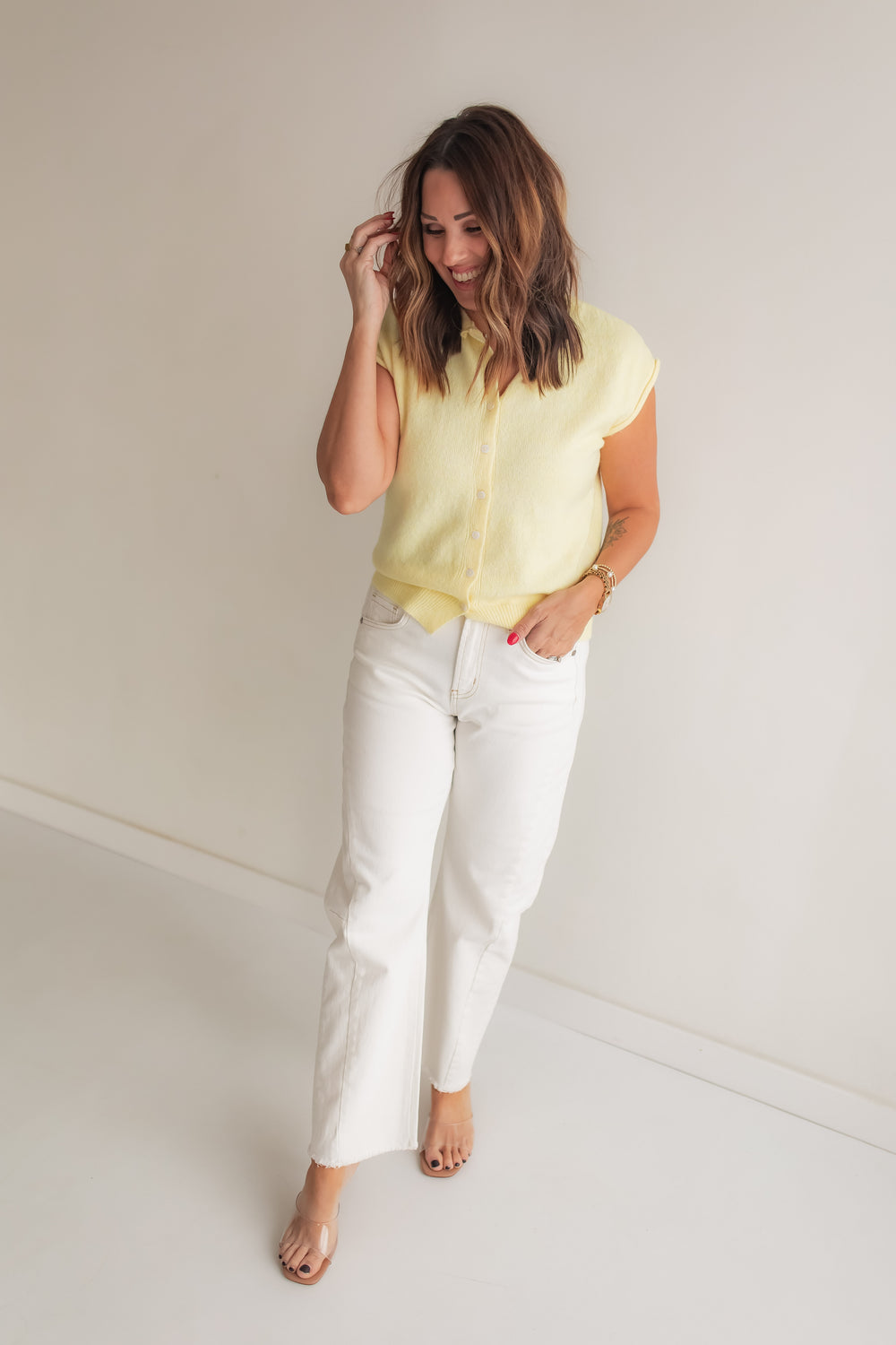 Light yellow cardigan sweater styled with white denim for a casual spring outfit