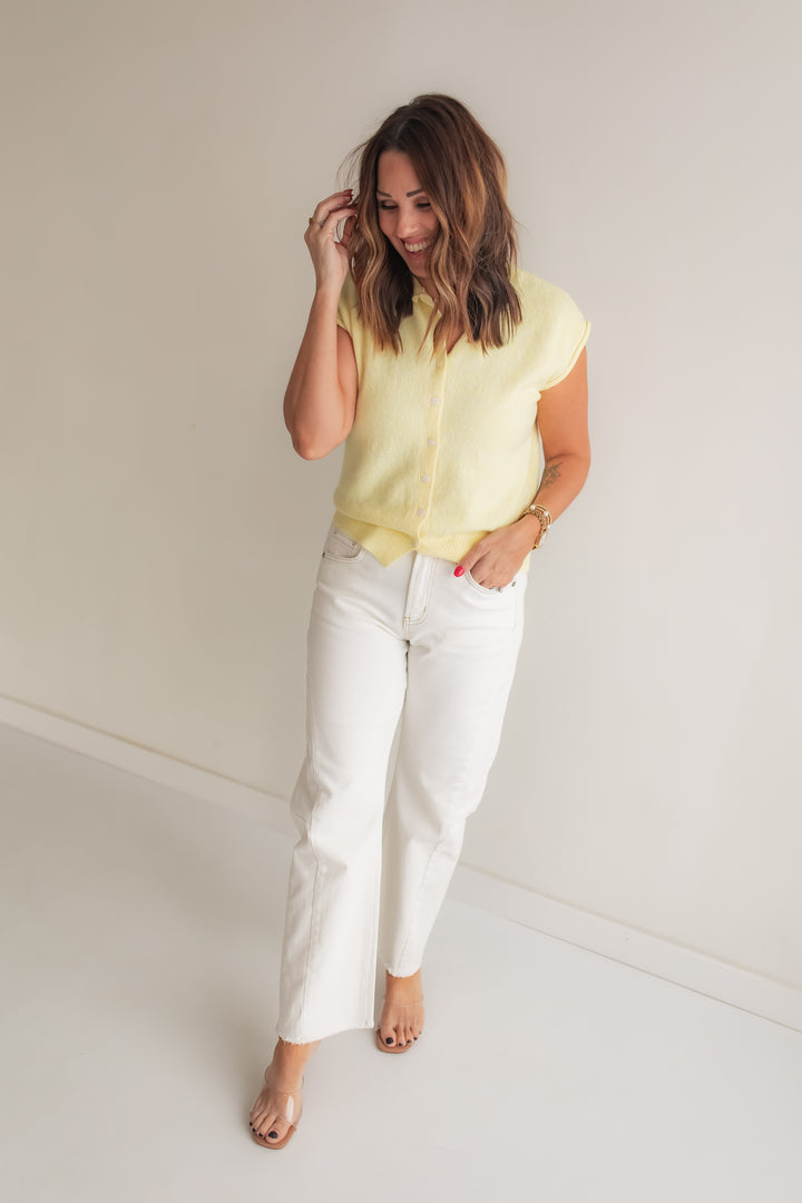 Light yellow cardigan sweater styled with white denim for a casual spring outfit