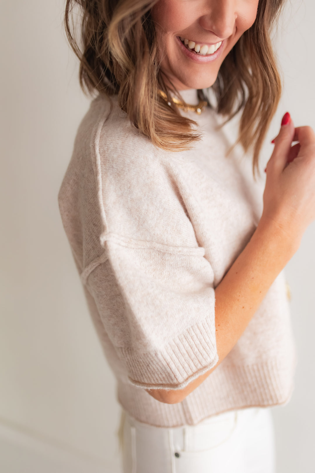 Close up of soft oatmeal knit mock neck sweater detail