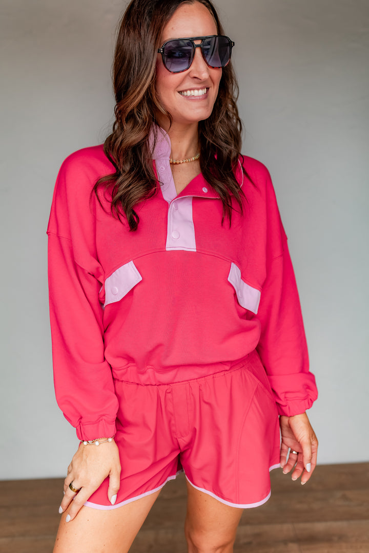 Pink athleisure matching set for women with pullover top and shorts styled for casual everyday wear