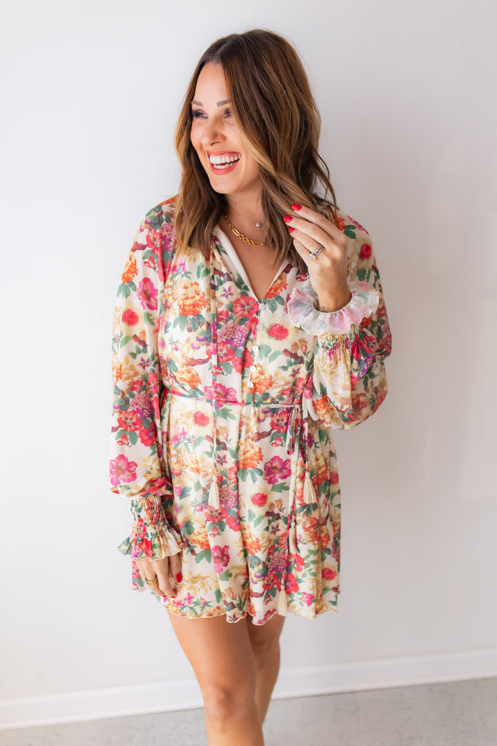 A lightweight floral romper with tassel tie detail