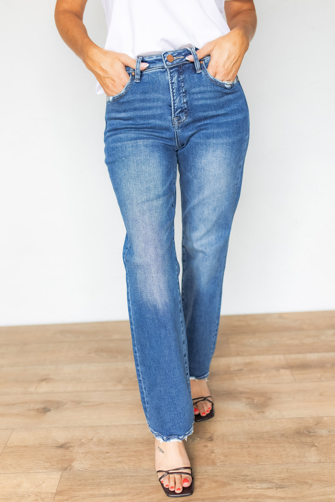 Front view of high rise straight leg jeans with white tee and black heels