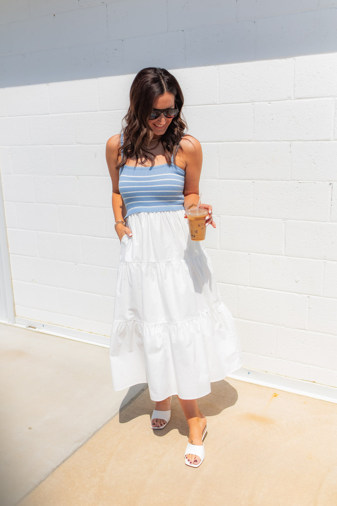 Blue and white striped midi dress with soft knit bodice and flowy skirt styled for a casual summer outfit
