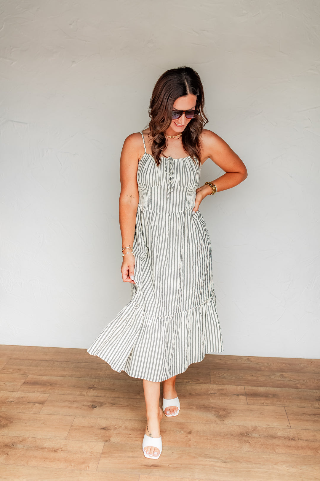 Striped midi dress with smocked bodice and flowy skirt styled for summer wear