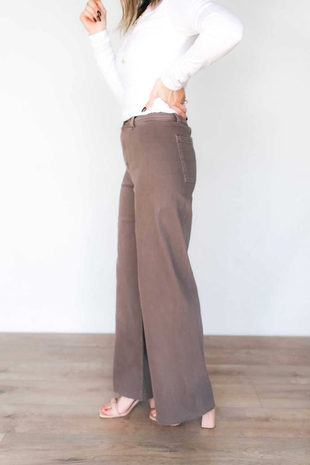 Close-up of side view detail on taupe brown wide leg denim