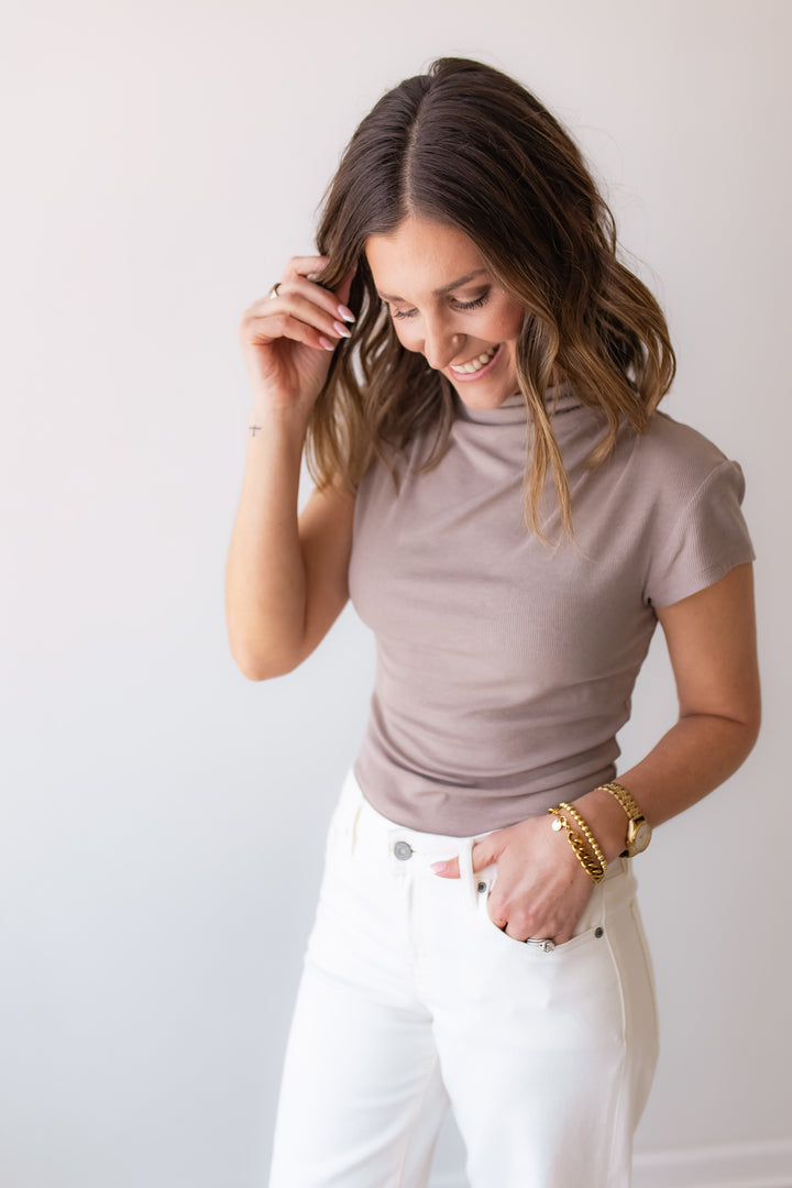 taupe fitted high neck short sleeve top styled with white denim for an everyday elevated outfit