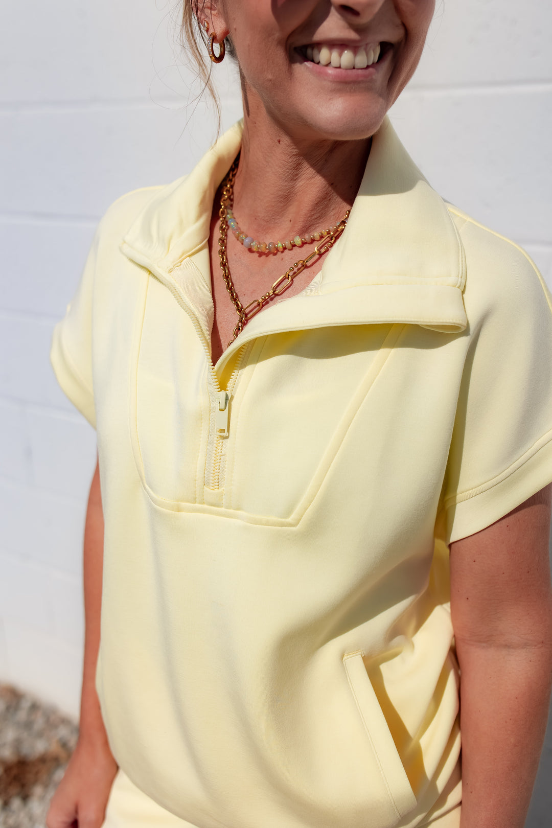Yellow half zip pullover styled as a casual athleisure outfit for everyday wear